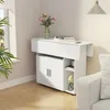 A white folding table with storage cabinets and shelves, set up in a room next to a sofa and window. Voir les images du produit
