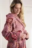 A woman wearing a floral-patterned robe. Produktbild-Vorschau