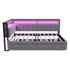 A grey upholstered daybed with a wooden frame and pink LED lighting is shown from the side against a white background. Voir les images du produit