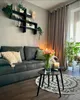 A living room scene with a sofa, coffee tables, and decor. Produktbild-Vorschau