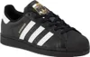 A black Adidas Superstar sneaker with white stripes and gold accents. Voir les images du produit