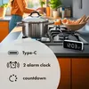 A kitchen scene with a person cooking, a pot on a stove, and a digital clock. Anteprima dell’immagine prodotto