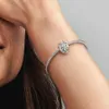 A close-up shot of a person's arm wearing a Pandora bracelet with a lion charm. Produktbild-Vorschau