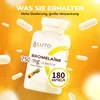 A bottle of bromelain supplement with capsules scattered around, set against a vibrant yellow and orange background. Produktbild-Vorschau