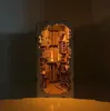 A detailed, illuminated miniature model of Diagon Alley from Harry Potter, presented as a book nook insert. Produktbild-Vorschau