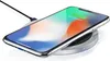 A smartphone is placed on a wireless charging pad, indicating it is charging. Produktbild-Vorschau