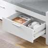 Geöffneter Schublade der SoBuy Schuhbank FSR74-W mit Kopfhörern und Buch Produktbild-Vorschau