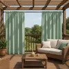An outdoor patio with furniture and curtains. Podgląd zdjęcia produktu