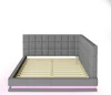 A grey upholstered bed frame with a slatted mattress base and pink LED lighting along the bottom edge, shown from the side. Produktbild-Vorschau