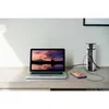 A laptop and a power strip are on a desk. Produktbild-Vorschau