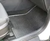 The image shows the interior of a car, focusing on a black rubber floor mat. Produktbild-Vorschau