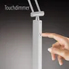 A close-up of a hand touching a touch dimmer on a lamp. Produktbild-Vorschau