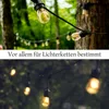 String lights hanging from trees in a garden setting, with a text overlay. Produktbild-Vorschau