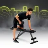 A man is performing a dumbbell row exercise on a weight bench. The background has a smoky effect and large, glowing text. Podgląd zdjęcia produktu