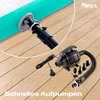 An inflatable mat and an electric pump are shown on a wooden floor. The mat is partially inflated and connected to the pump via a hose. Produktbild-Vorschau
