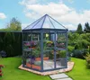 A greenhouse filled with plants in a garden setting. Voir les images du produit