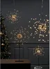 A dark room with a Christmas tree on the left and several starburst LED lights on stands. Produktbild-Vorschau