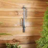 A thermometer hangs on a wooden wall. Náhľad obrázku produktu