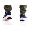 A pair of navy blue NIKE Downshifter 12 men's shoes, size 44, shown from the back and side views, worn with green cargo pants. Anteprima dell’immagine prodotto