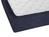 A close-up view of a mattress with a dark blue fitted sheet. Produktbild-Vorschau
