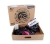 A pair of black and pink roller skates are shown inside their opened cardboard box. Voir les images du produit