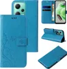 Collage of images showing a blue flip phone case with floral and butterfly designs from different angles. Produktbild-Vorschau
