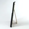 A side view of a black picture frame with a stand. Náhled obrázku produktu