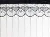 A close-up of black lace with a heart pattern against a white background. Náhled obrázku produktu