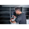 A man is using a cordless drill to assemble a cabinet. Náhled obrázku produktu