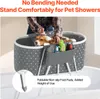 A dog being bathed in a portable tub placed in a bathtub. Produktbild-Vorschau