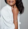 A woman wearing a white shirt and a silver bracelet with a heart-shaped charm. Náhled obrázku produktu