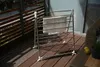 A drying rack with a towel on it, placed on a wooden deck. Anteprima dell’immagine prodotto