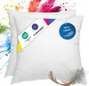Two white pillows with tags and a feather against a colorful powder explosion background. Náhľad obrázku produktu