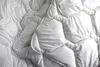 A close-up view of a white quilted comforter. Produktbild-Vorschau