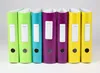 A row of colorful binders on a plain background. Voir les images du produit