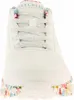 A close-up front view of a white Skechers sneaker with a floral pattern on the sole. Produktbild-Vorschau