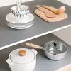 Kitchen items are neatly arranged on two shelves, with a focus on cookware and tableware. Náhled obrázku produktu