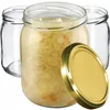 Three glass jars are shown, with one filled with sauerkraut and a gold lid resting beside it. Two empty jars are partially visible behind the filled one. Anteprima dell’immagine prodotto