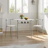 A dining set with a round table and two chairs in a bright room with windows. Produktbild-Vorschau