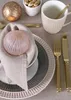 A table setting with plates, cutlery, a mug, and decorative items. Produktbild-Vorschau