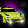 A bright yellow remote-controlled car with black and purple accents, illuminated by bright headlights and a purple gradient background. Voir les images du produit