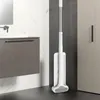 A white microfiber mop is leaning against a dark gray wall in a modern bathroom setting, next to a vanity and a cabinet. Podgląd zdjęcia produktu