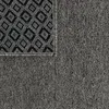 A close-up view of a rug, showing the texture of the fabric and a portion of the patterned backing. Anteprima dell’immagine prodotto