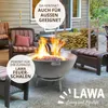 A fire pit with flames on a patio, surrounded by outdoor furniture and a wood rack. Podgląd zdjęcia produktu