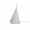 Side view of a light gray Google Nest Hub smart display plugged in and resting on a white surface. Produktbild-Vorschau