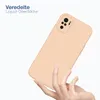 A hand holding a peach-colored phone case against a white background. Produktbild-Vorschau
