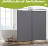 A gray fabric room divider set up in a bathroom next to a bathtub. Voir les images du produit