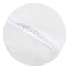 A close-up view of a white pillow with a zipper. Produktbild-Vorschau