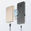 A magnetic wireless power bank is shown next to a smartphone, with charging cables connected to both devices. Voir les images du produit