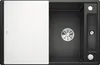 A top-down view of a black kitchen sink with a white sliding cover and a silver drain. Podgląd zdjęcia produktu